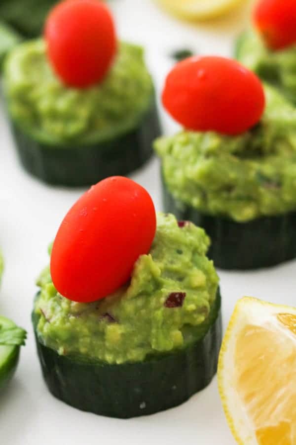 cucumber canapes on a white table.