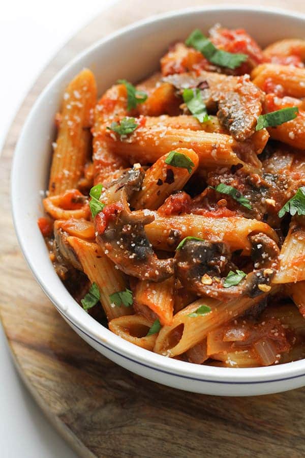 finished dish in a bowl covered in basil.