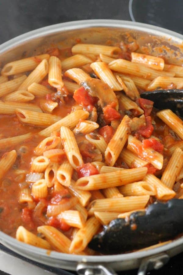 penne and tomato sauce in a frying pan.