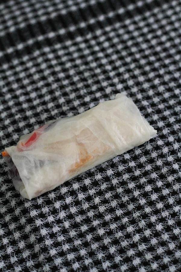 a rice paper roll on a kitchen towel.