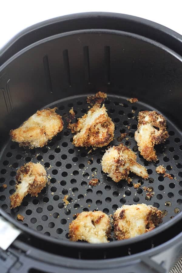 bang bang cauliflower in an air fryer basket.