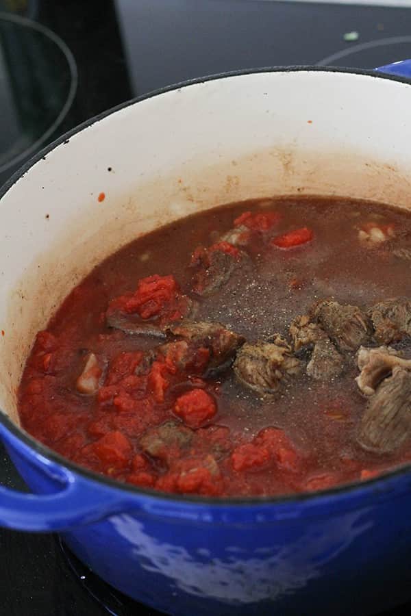 ingredients cooking in a dutch oven.