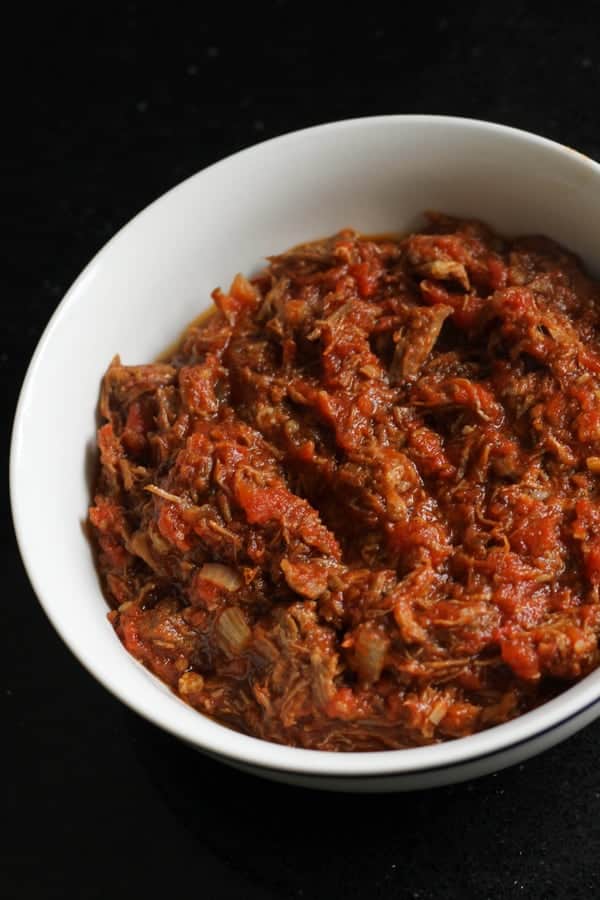 braised beef in a white bowl.