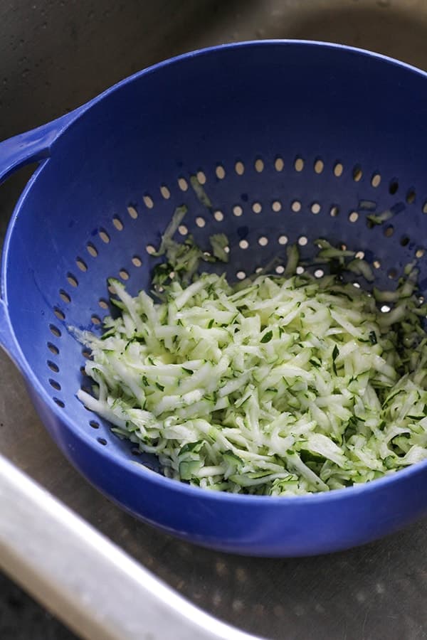 grated zucchini in a colander.