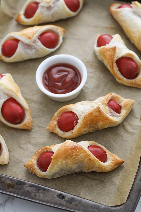 pigs in a blanket on a baking tray.