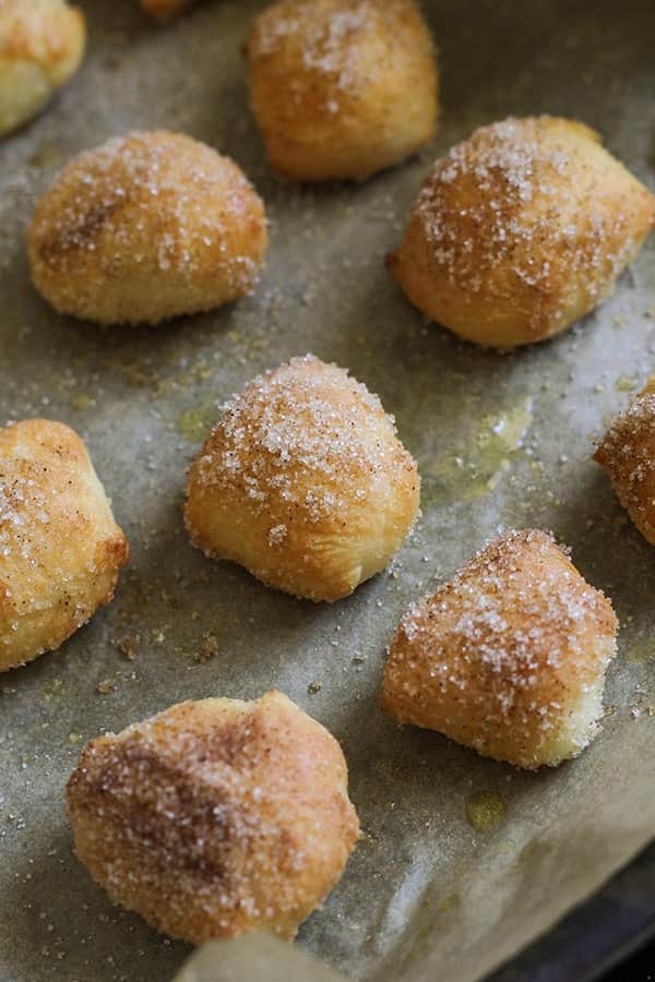 pretzel bites covered in cinnamon sugar on a baking tray.
