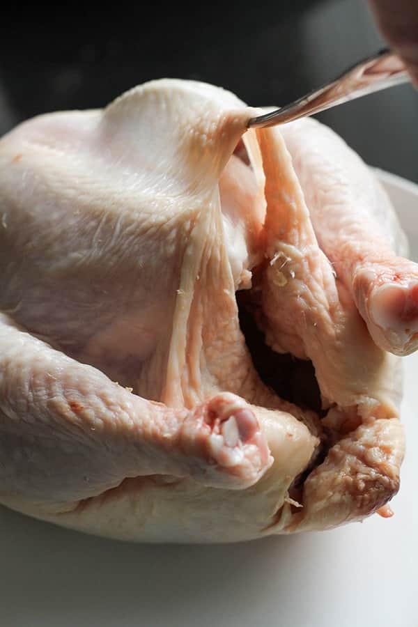 whole chicken on a white plate.