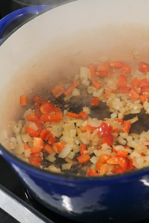 diced onion and capsicum cooking in a large pot.