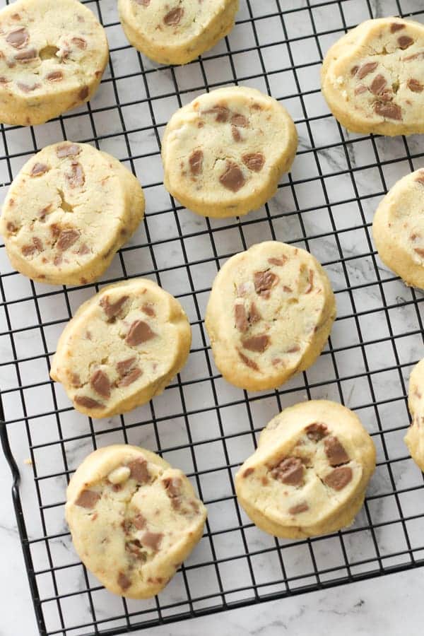 chocolate chip shortbread cookies on a wire cooling rack.