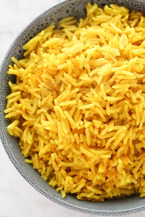 yellow rice in a blue bowl.