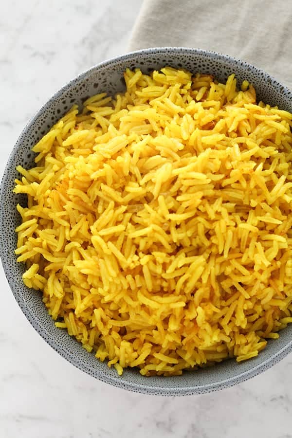 yellow rice in a blue bowl.