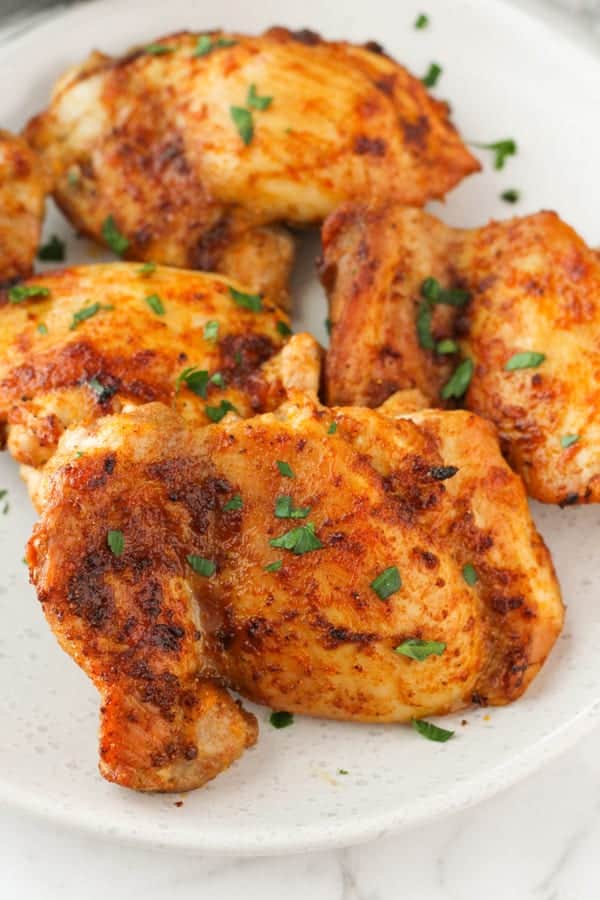 chicken thighs on a plate with parsley.
