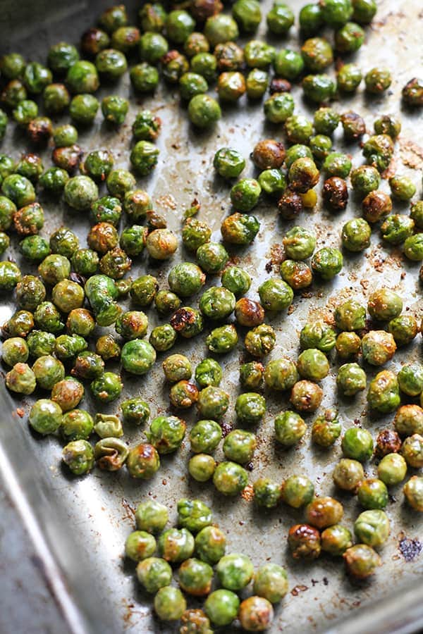 roasted peas on a baking tray.