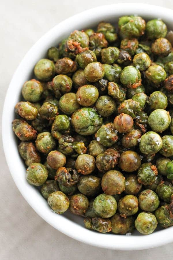 crunchy roasted peas in a white bowl.