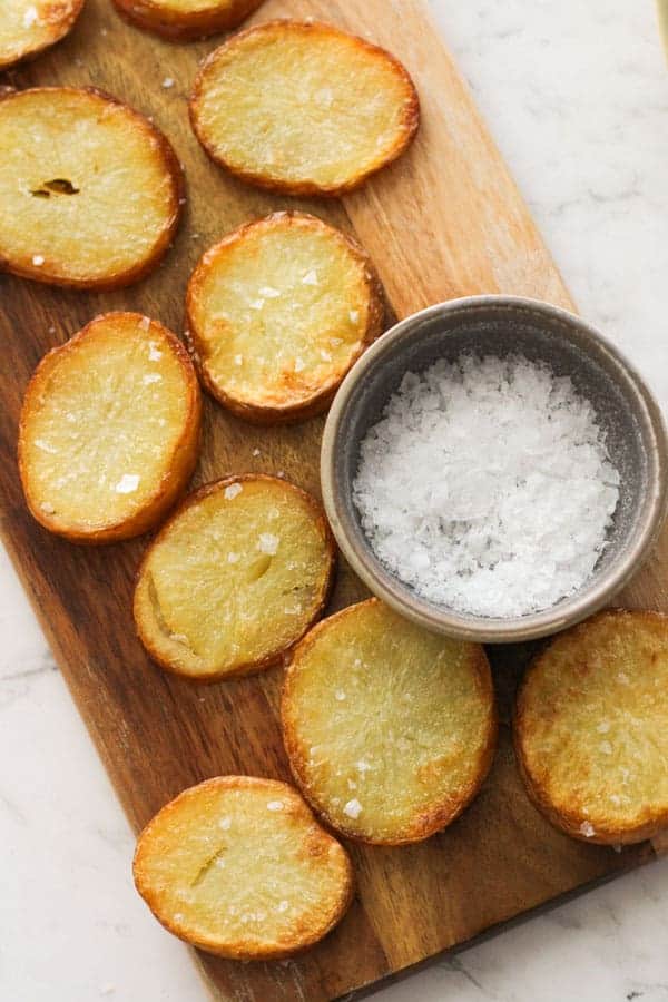 salt and vinegar potatoes on a wooden serving board.