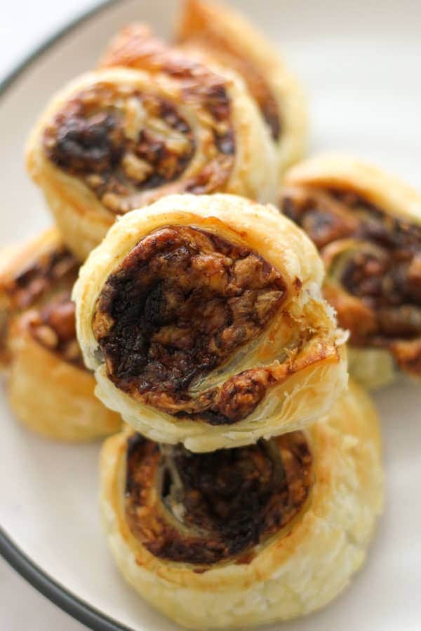 vegemite pinwheels stacked on top of each other on a white plate.