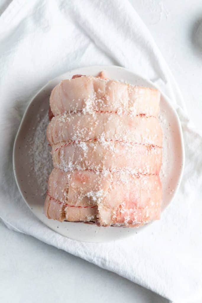 roast pork heavily salted on a plate.
