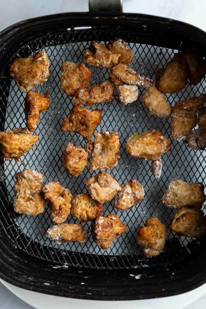 karaage chicken in an air fryer basket.