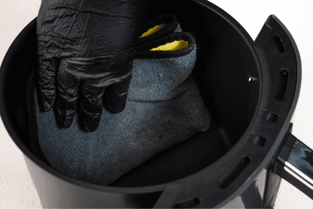 Cleaning air fryer basket with microfiber cloth