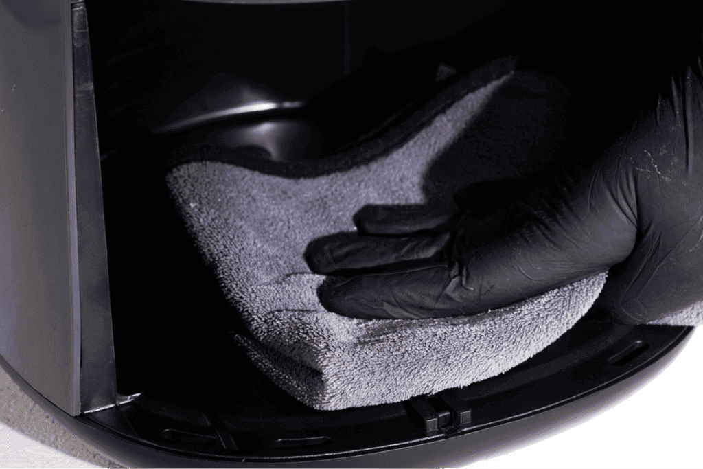 Cleaning air fryer interior with Microfiber cloth