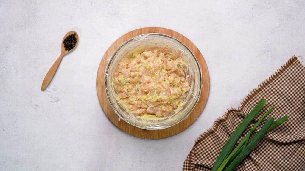 Mixture in mixing bowl cover with plastic wrap